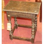 An antique joined oak joint stool, having a chipped carved edge raised on turned and square cut