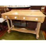 A Victorian pine ledge back two drawer wash stand, raised on twin bobbin end turn supports united by