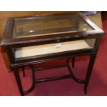 An Edwardian mahogany hinge top bijouterie table, on square tapering supports united by shaped