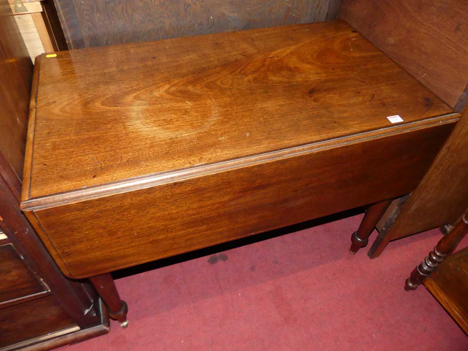 A Victorian mahogany round cornered Pembroke table, having single end drawer and on turned supports