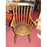 An early 20th century elm and beech stick back elbow chair, width 52.5cm