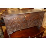 An antique joined and relief carved oak hinge top blanket chest, width 95cm
