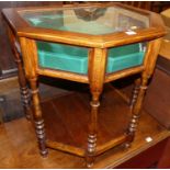 An oak bevelled glass credence shaped hinge top bijouterie table, raised on turned supports to lower