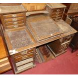 An Edwardian oak Dickins desk, having a raised superstructure with twin banks of four drawers, slope