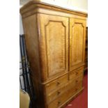 An early Victorian satin wood round cornered linen press, the twin panelled upper doors enclosing