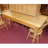 A modern pine round cornered farm house kitchen table raised on turned supports, length 182.5cm,