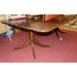 A mahogany twin pillar round cornered dining table, with single drop-in leaf, max length 217.5cm
