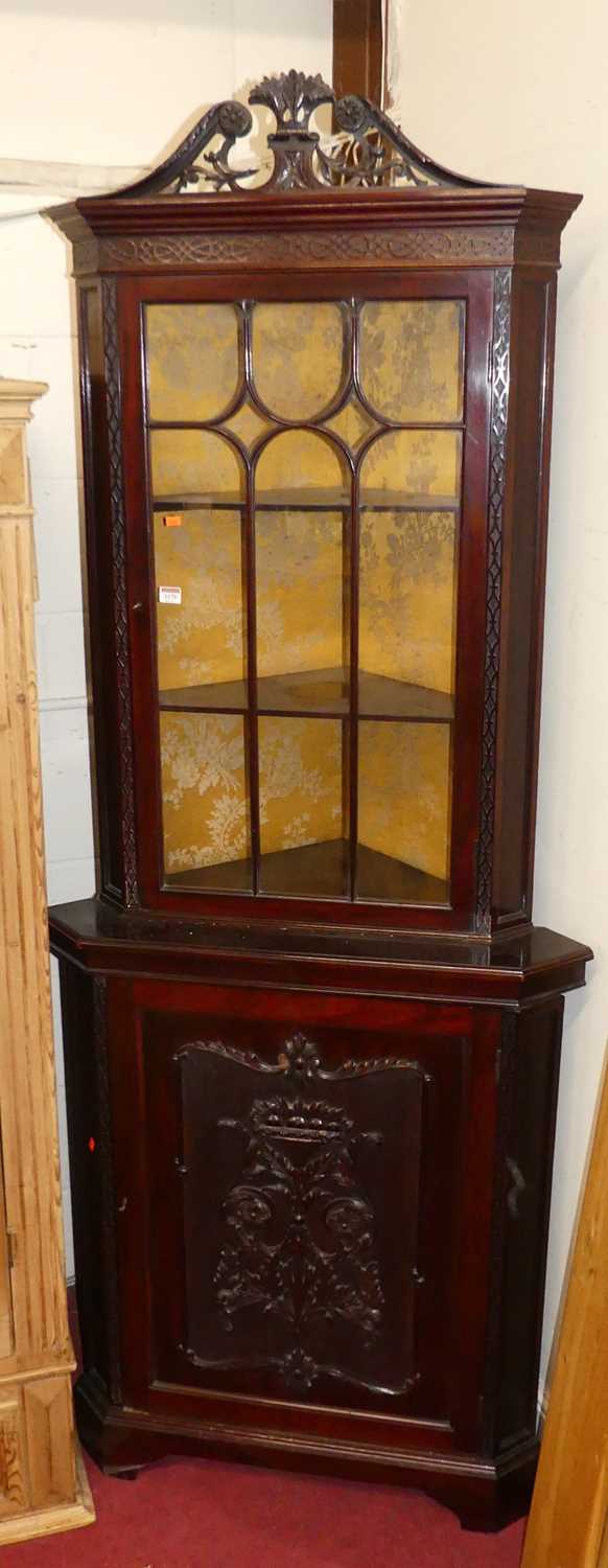 A circa 1900 Chippendale Revival floral fret carved mahogany corner cupboard, having glazed upper