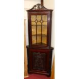 A circa 1900 Chippendale Revival floral fret carved mahogany corner cupboard, having glazed upper