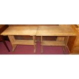 A pair of early 20th century oak trestle two-tier side tables, each width 91cm