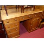 A Victorian oak round cornered kneehole writing desk, having an arrangement of six drawers and