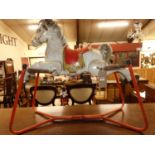 A mid 20th century painted and pressed metal child's sprung rocking horse, length 96cm