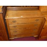 An early 20th century oak ledge back chest of four long drawers on squat cabriole supports, width