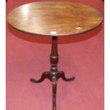 An early 19th century mahogany oval tilt top pedestal tripod occasional table raised on hipped