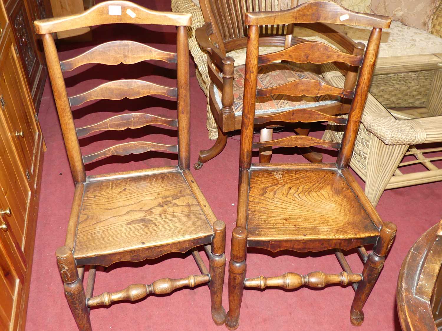 A set of three provincial 19th century elm and oak ladder back panelled seat dining chairs, together