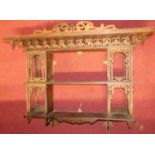 An Edwardian floral fret carved two-tier open wall shelf, width 88.5cm