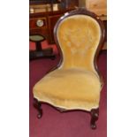 A mid-Victorian mahogany framed and button mustard dralon upholstered nursing chair