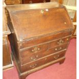 An 18th century provincial oak slope front writing bureau, having two short over two long