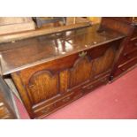 An 18th century joined oak three panelled mule chest, having twin short lower drawers, width 140cm