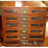 An early 20th century mahogany bank of six drawers, with flush brass handles and titled Clapperton's