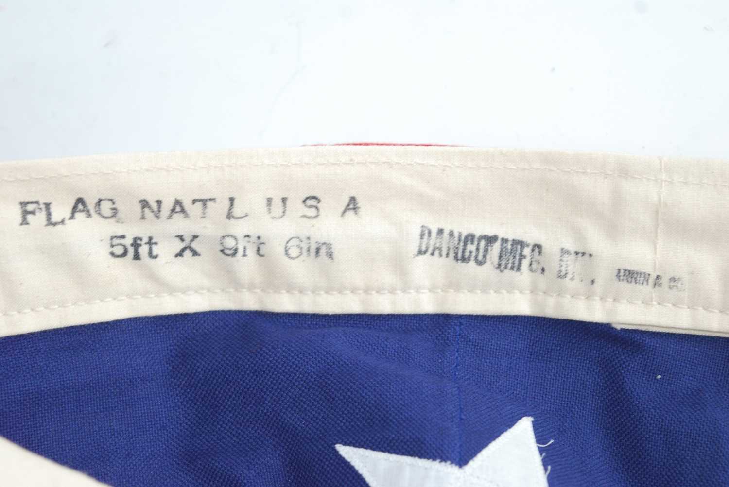 A large American Stars and Stripes flag of stitched cotton construction, having fifty stars, stamped - Image 2 of 2