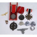 A German War Merit Cross with swords, together with an SA Sports badge, an SS totenkopf x3, an eagle
