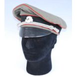 A reproduction German Officer's peaked cap, together with an M43 field cap. (2)The field cap with