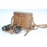 A pair of WW I private purchase binoculars, in leather case.