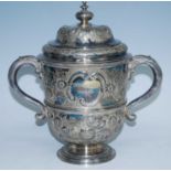 A large Victorian silver plated trophy cup and cover, the ogee domed cover with squat circular