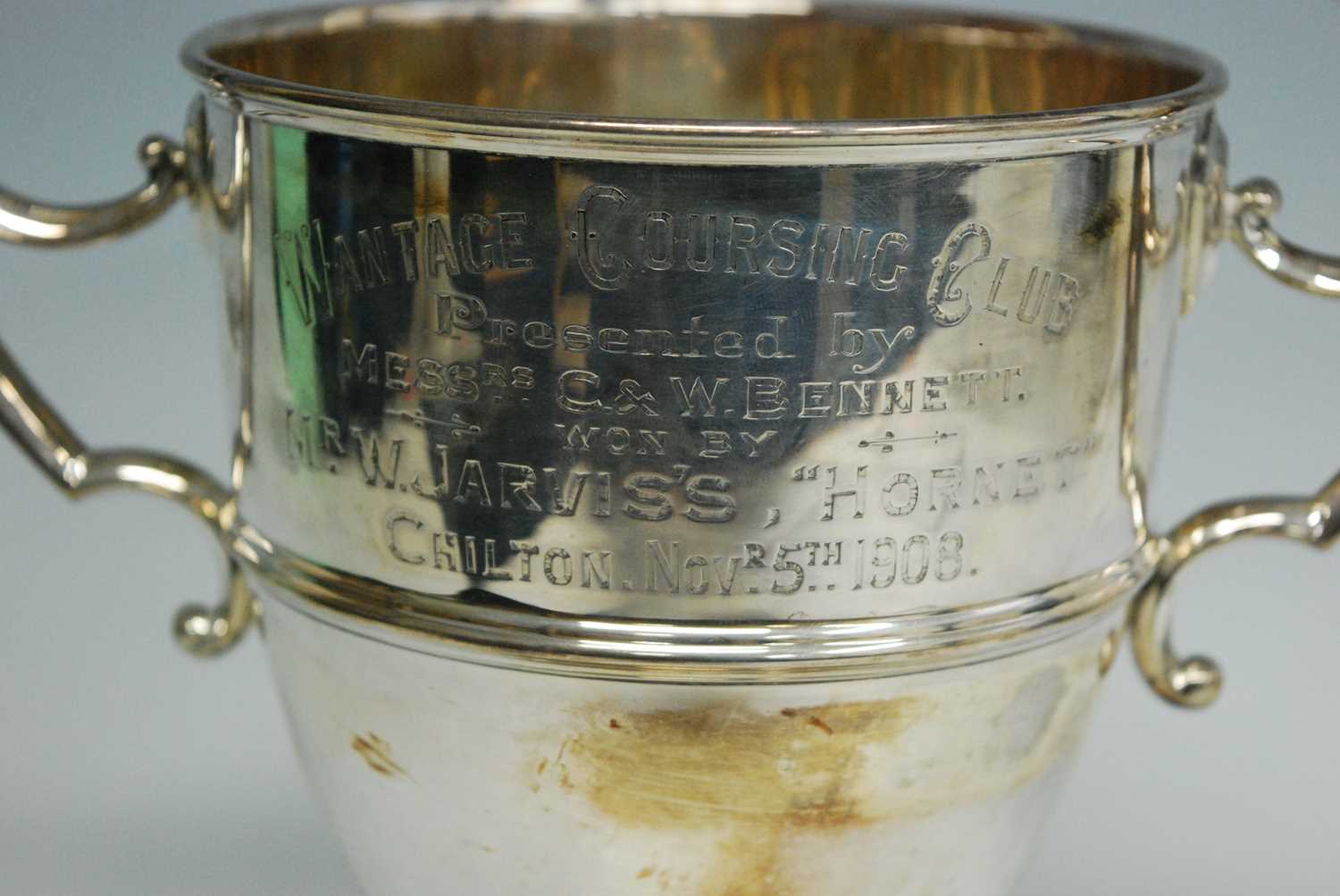 An Edwardian silver trophy cup, the body with a central band and twin c-scroll handles, engraved " - Image 2 of 3