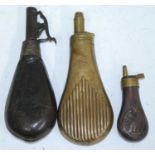 An early 20th century brass powder flask, of fluted pear shape, the nozzle stamped Sykes, 19cm,