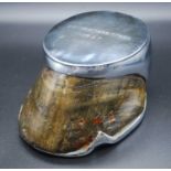 A 1930's lacquered horse hoof, with chrome shoe and mount inscribed Gangsters Moll 1937, h.7cm.
