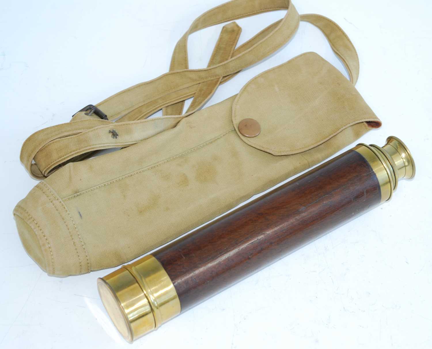 A late 19th/early 20th century mahogany clad and lacquered brass three drawer military telescope,