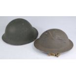 A WW II British Army Mk III steel turtle helmet, having a leather liner and canvas chin strap,