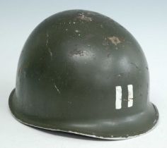 A U.S. M1 steel helmet, marked II to the front, having a canvas liner and chin strap.