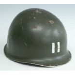 A U.S. M1 steel helmet, marked II to the front, having a canvas liner and chin strap.