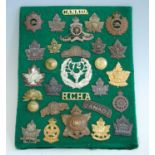 A collection of cap badges and insignia, mainly being Canadian and New Zealand Regiments to