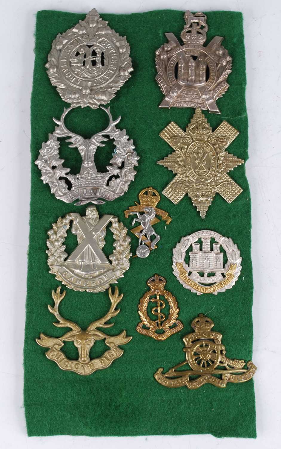 A small collection of cap and collar badges, to include Argyll and Sutherland Highlanders, King's