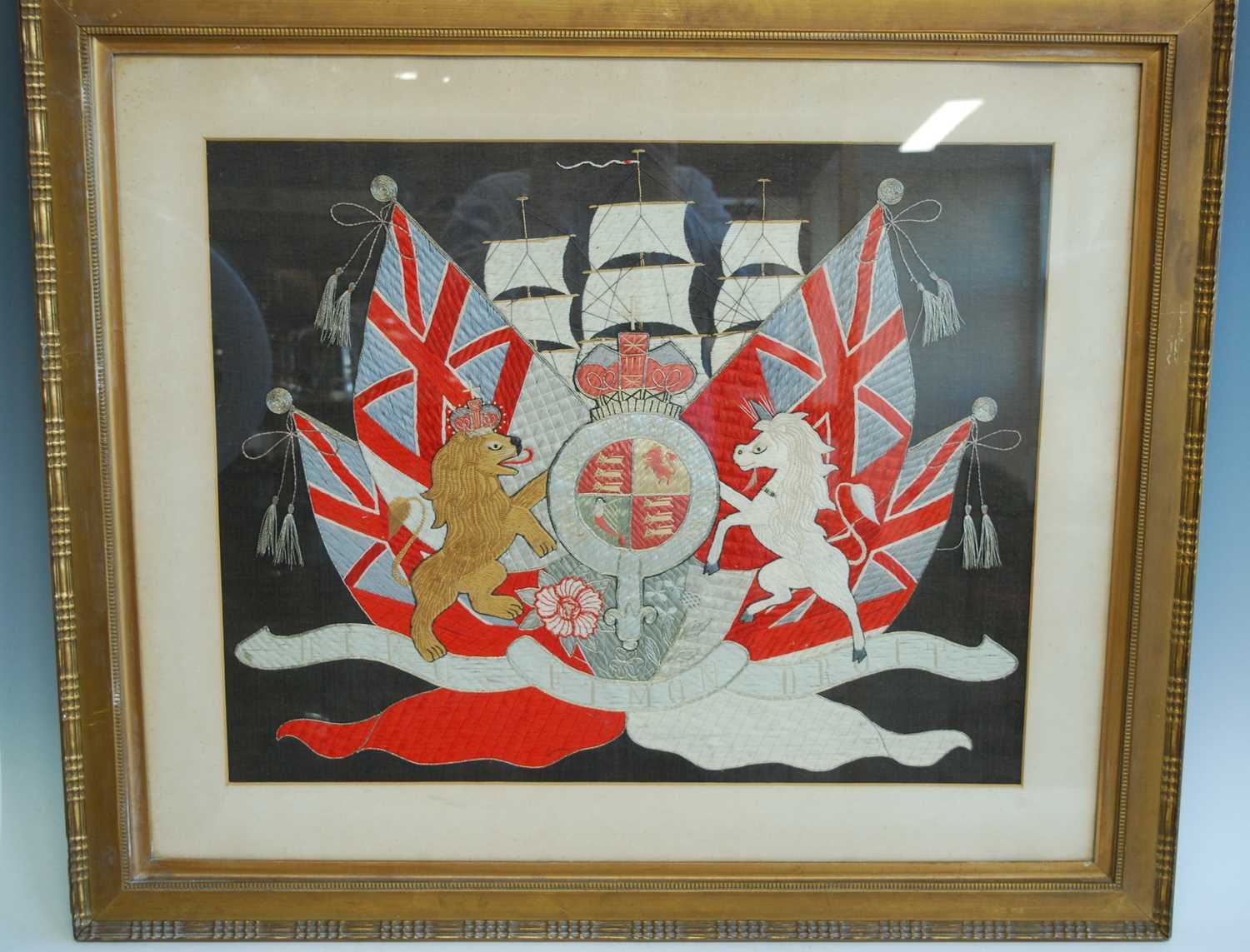 A WW I period silk embroidered panel, the central royal crest flanked by a lion and unicorn with