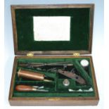 A Victorian oak pistol case, having a green felt lined interior containing various eccoutrements