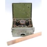 A post WW II British Army Field Camp Stove, w.24, d.24, h.12cm, together with a wooden gauge,