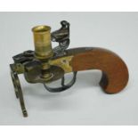 A 1960's Italian novelty tinder pistol table lighter, having a flintlock action, brass frame and