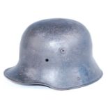 A German M1916 steel helmet, lacking liner.