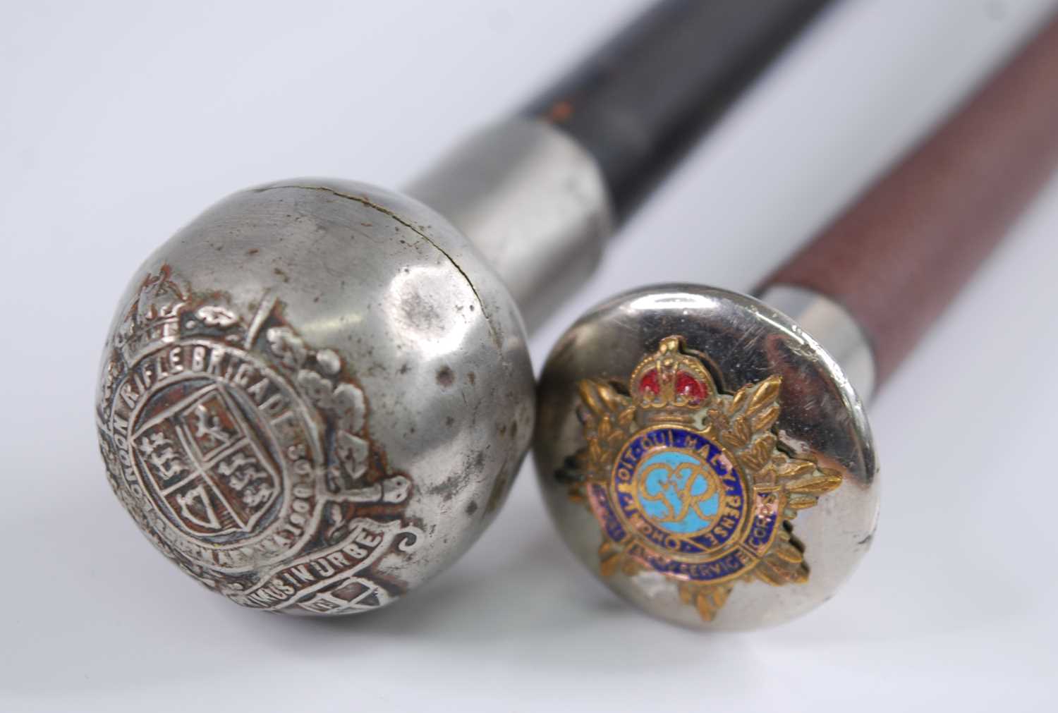 A early 20th century swagger stick, having an ebonised shaft and silver plated cap with crest for