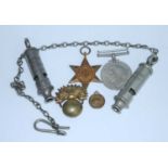 A WW II 1939-1945 Star and Defence medal, together with an artillery flaming grenade badge, a
