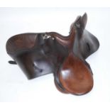 A brown leather saddle, bearing a label for M & J Saddlery, Lichfiield, together with one other with