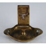 A brass ashtray of shaped square form with pierced corners, the integral matchbox holder with