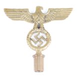 A German NSDA flag pole finial, in the form of spread eagle holding a wreath with swastika within,