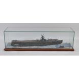 A large scratch built model of the aircraft carrier HMS Pursuer, within a glazed display case on a