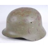 A Spanish Civil War M1926 steel helmet, with canvas and leather liner and canvas chin strap.
